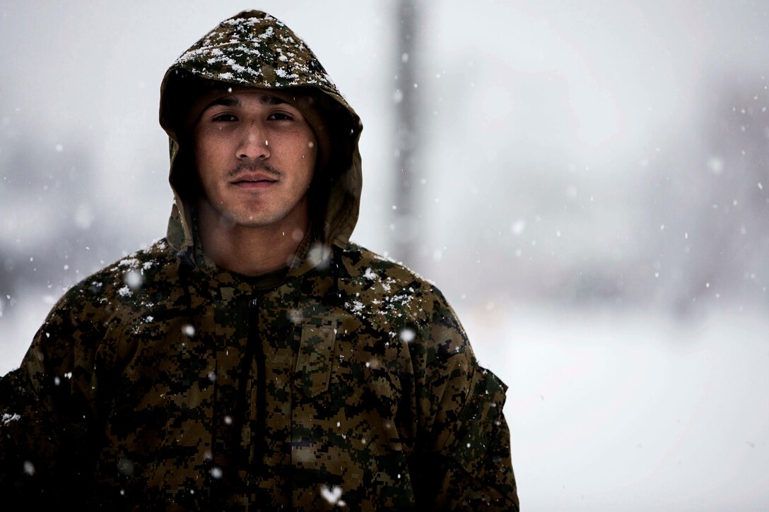 U.S. Marine Corps Pfc. Tyson Trombley, an engineer equipment mechanic with 3rd Battalion, 12th Marines, Headquarters Battery, 3D Marine Division prepares vehicles to operate in snow at Yausubetsu Maneuver Area, Japan, during Artillery Relocation Training Program (ARTP) 15-3, Nov. 24, 2015. ARTP enables Marine Corps artillery units to conduct battery level training in order to improve mission readiness by training to artillery mission essential tasks. (U.S. Marine Corps photo by Lance Cpl. Juan Bustos/Released)