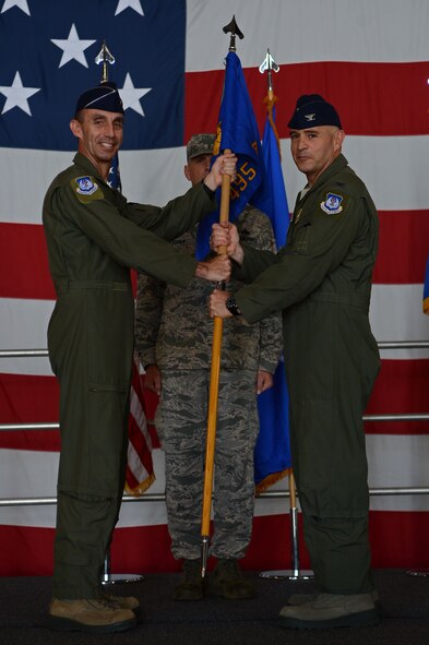 U.S. Air Force Maj. Gen. Scott Zobrist, Ninth AF commander, hands the 495th Fighter Group guidon to Col. Michael Dean, 495th FG incoming commander, during a change of command ceremony at Shaw Air Force Base, S.C., June 24, 2016. The ceremony formally recognized Dean’s assumption of command from the group’s previous commander, Col. James McCune. (U.S. Air Force photo by Senior Airman Zade Vadnais) 