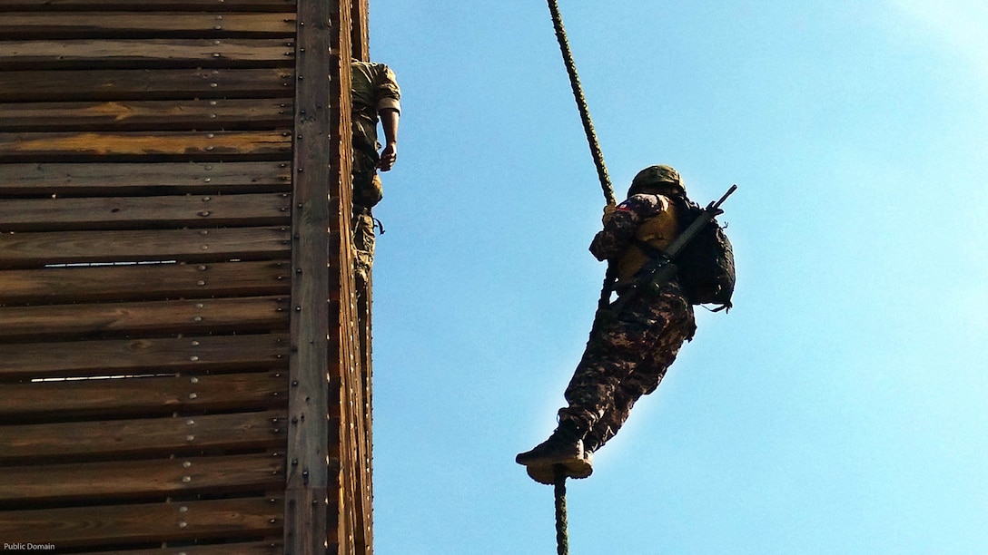 A partner nation servicemember fast ropes from a tower at the JDF Up Park Camp in Kingston, Jamaica during Exercise Tradewinds-2016, Thursday, June 23, 2016. Fast roping is a method used by troops to descend from structures or helicopters quickly without using anything other than their hands and feet to control the speed of their descent. Tradewinds is a U.S. Southern Command-sponsored exercise hosted by Jamaica and includes 17 partner nations who are engaged in training activities to enhance skills, partnership and security cooperation throughout the region.