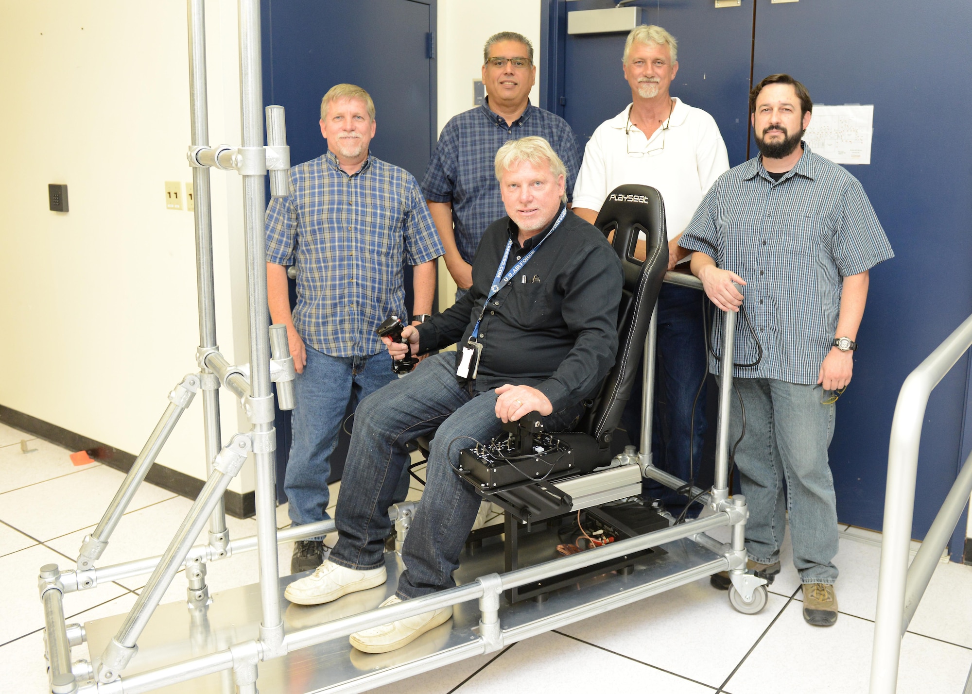The Portable Manned Interactive Cockpit being built by members of the 772nd Test Squadron should be completed and ready for use by July 2016. The innovation team members are, from rear left to right, Curtis Westfall, Victor Cruz, Gary Johnson, Kevin Dolber and Orion Westfall, seated. (U.S. Air Force photo/Kenji Thuloweit)