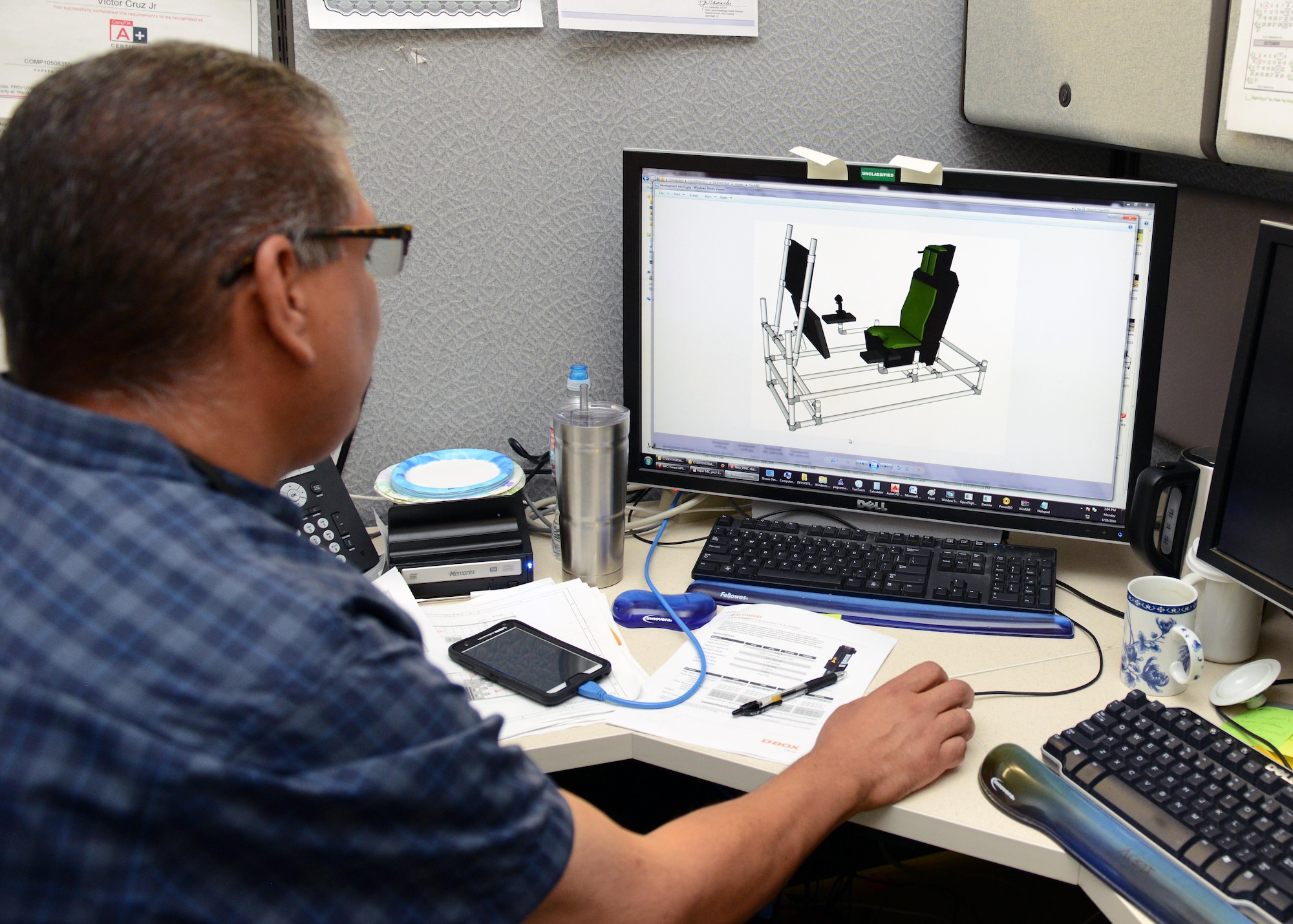 Victor Cruz, of the 772nd Test Squadron, used a 3-D design program to help come up with the design of the Portable Manned Interactive Cockpit. (U.S. Air Force photo/Kenji Thuloweit)