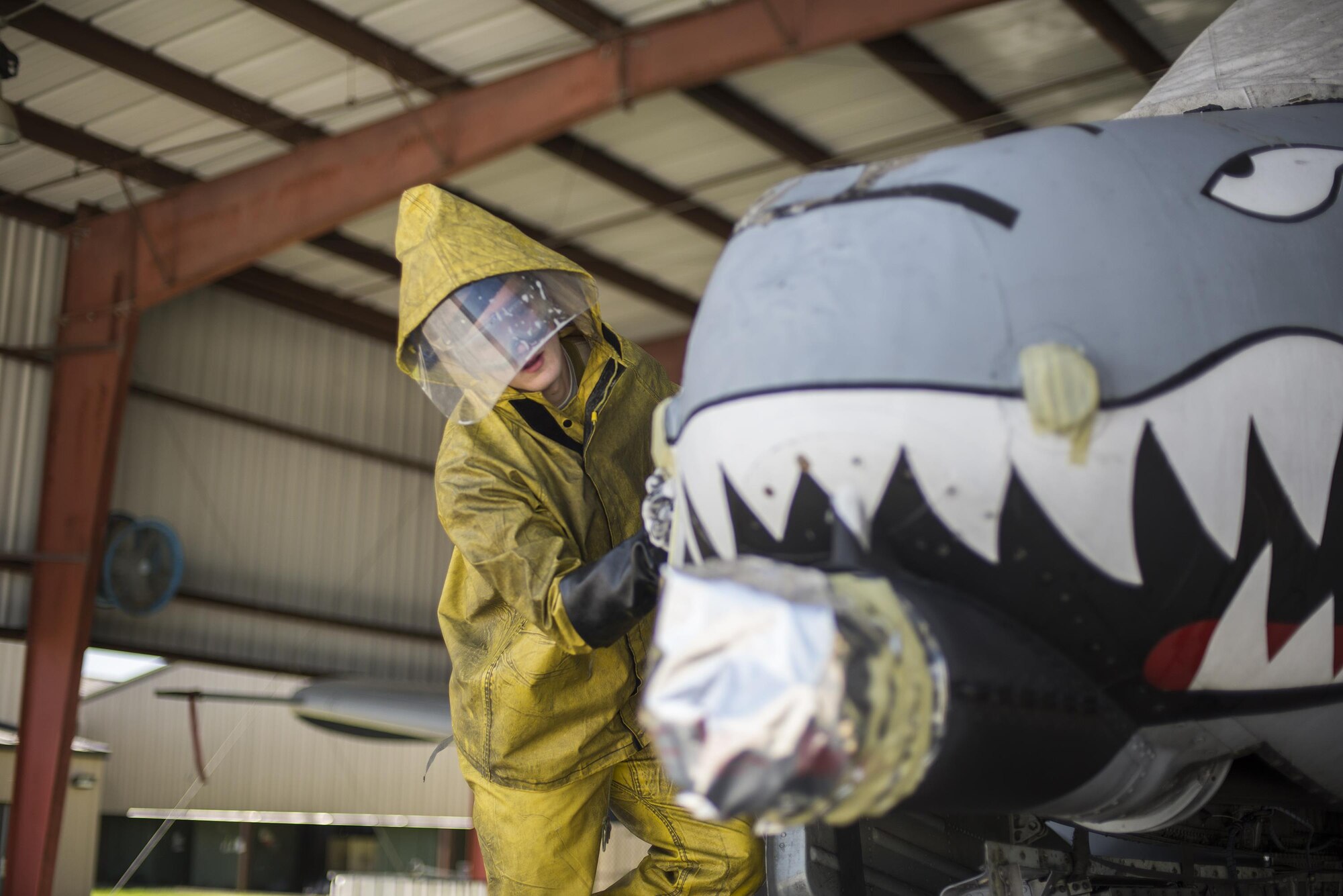 U.S. Air Force Senior Airman Brandon Vandyke, 23d Aircraft Maintenance Squadron crew chief, scrubs the side of an A-10C Thunderbolt II, June 16, 2016, at Moody Air Force Base, Ga. Airmen begin the wash process by covering every hole of the aircraft to avoid water damage to valuable equipment. (U.S. Air Force photo by Airman Daniel Snider/Released)