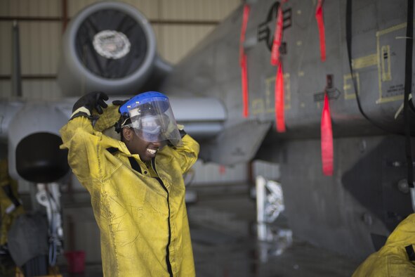 U.S. Air Force Senior Airman Zachary Moore, 23d Aircraft Maintenance Squadron avionics technician, laughs while pulling his hood up during an A-10C Thunderbolt II wash, June 16, 2016, at Moody Air Force Base, Ga. A wash team commonly consists of the aircraft’s crew chiefs, a weapons technician and an avionics technician. (U.S. Air Force photo by Airman Daniel Snider/Released) 