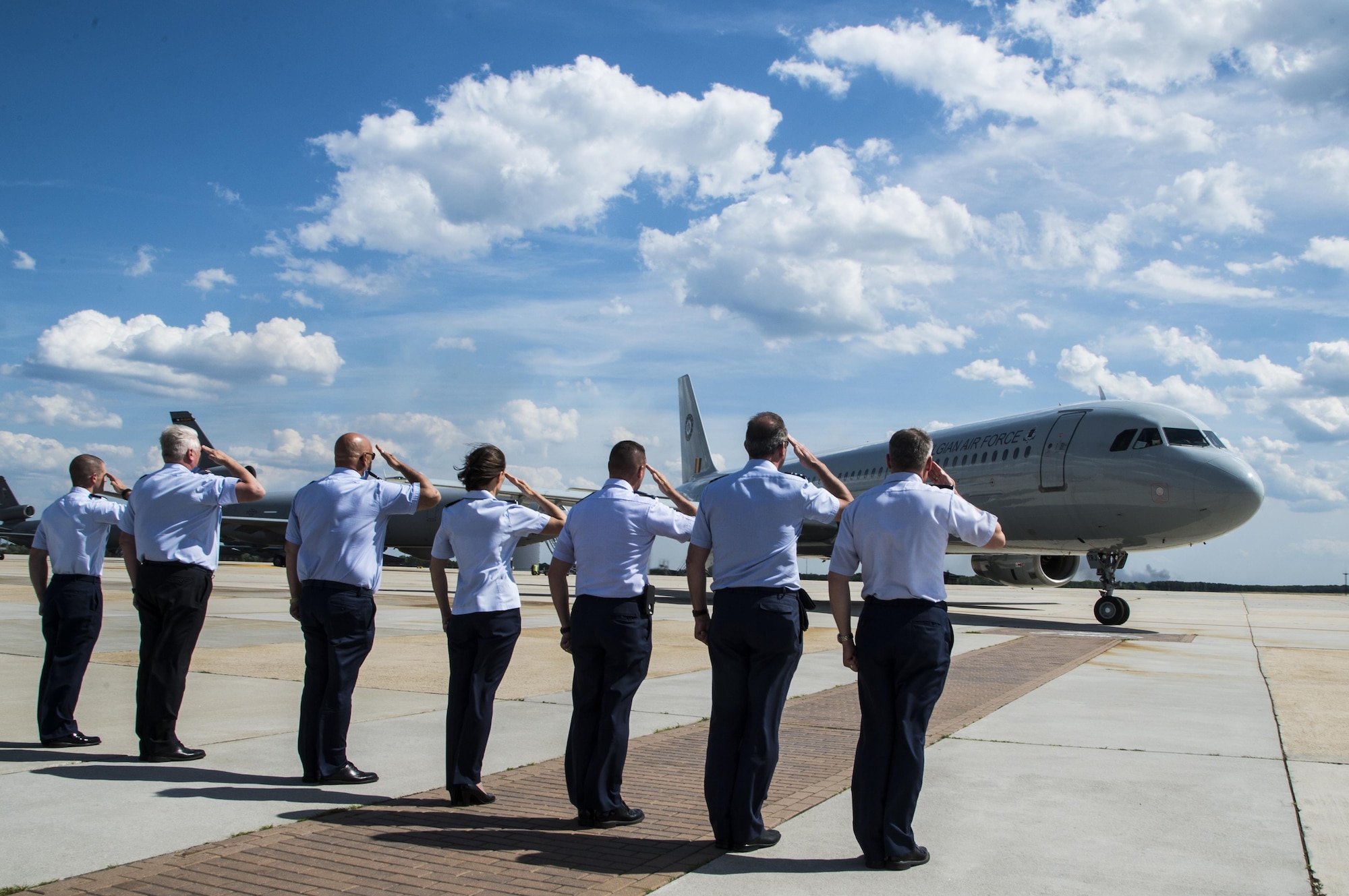 Belgian military and U.S. Air Force members salute a Belgian aircraft carrying more than 60 military members for a tour of Joint Base McGuire-Dix-Lakehurst, New Jersey, June 22, 2016. The tour is given to the students of the Advance Staff Course held in Brussels every year as part of their capstone requirement that includes a visit to the U.N. in New York, New York, the Pentagon in Washington, District of Columbia, and a tour of Norfolk Naval Air Station, Virginia. (U.S. Air Force photo by Tech. Sgt. Gustavo Gonzalez/Released)(U.S. Air Force photo by Tech. Sgt. Gustavo Gonzalez/Released)