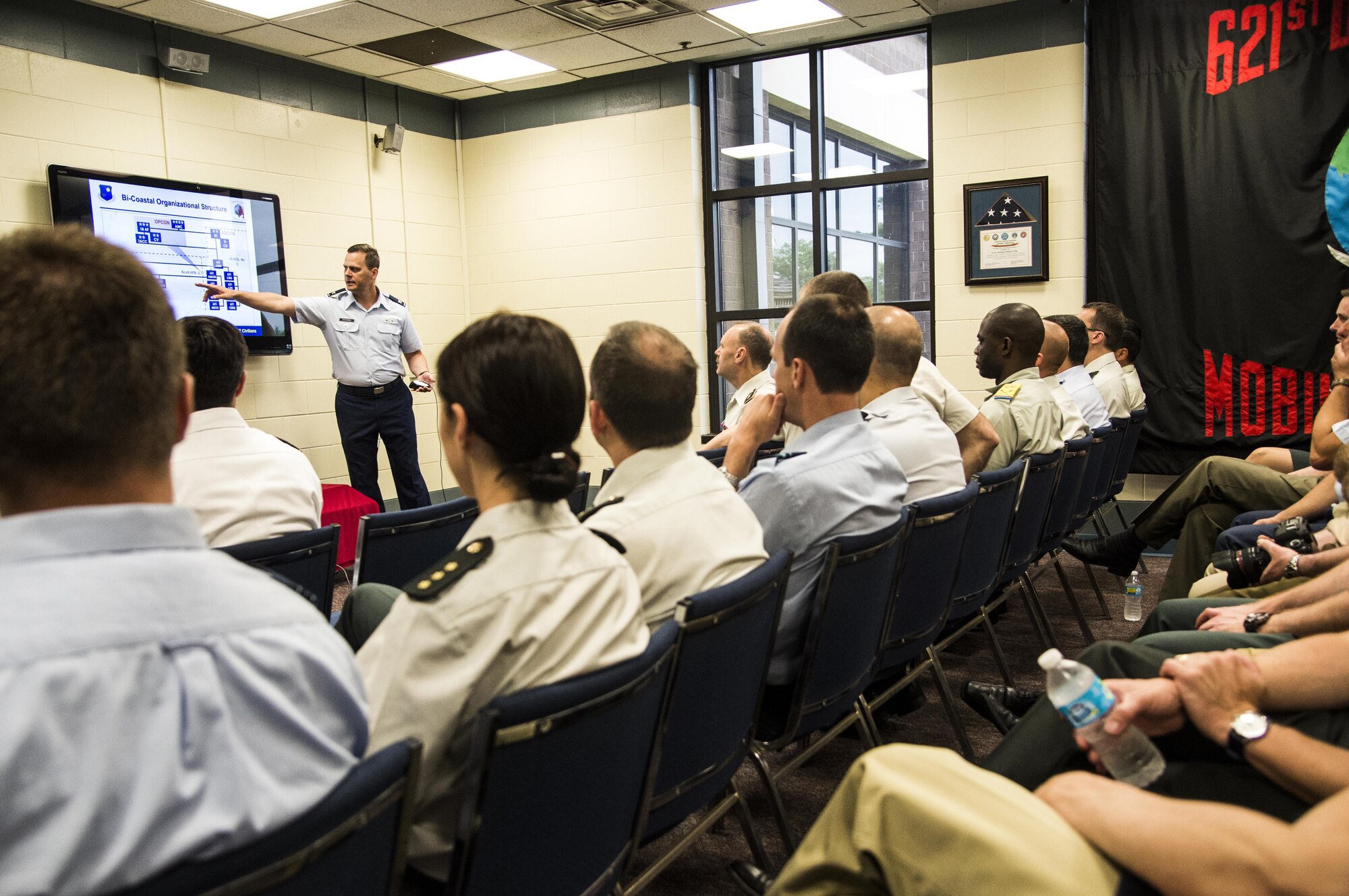 Col. Joel Safranek, 621st Contingency Response Wing vice commander, briefs approximately 60 members of the Belgian military members on CRW capabilities during a tour of the 621st Contingency Response Wing at Joint Base McGuire-Dix-Lakehurst, New Jersey, June 23, 2016. The 621 CRW is a mission ready, mobile force deployable to any location world-wide to support the handling of aircraft and cargo within 12 hours of notice. Additional capabilities include building partnership capacity in African and South American nations, providing air mobility expertise to Army and Marine Corps commanders, and theater level operational level planning and command and control. (U.S. Air Force photo by Tech. Sgt. Gustavo Gonzalez/Released)