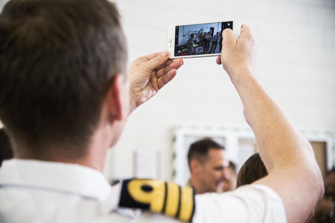 A member of the Belgian military takes a photo of the Air Mobility Liaison Officer capability demonstration during a tour of the 621st Contingency Response Wing at Joint Base McGuire-Dix-Lakehurst, New Jersey, June 23, 2016. AMLOs train, advise, and educate joint forces on air mobility, coordinate air mobility command and control aspects of an exercise or operation, and conduct drop zone and landing zone operations. (U.S. Air Force photo by Tech. Sgt. Gustavo Gonzalez)