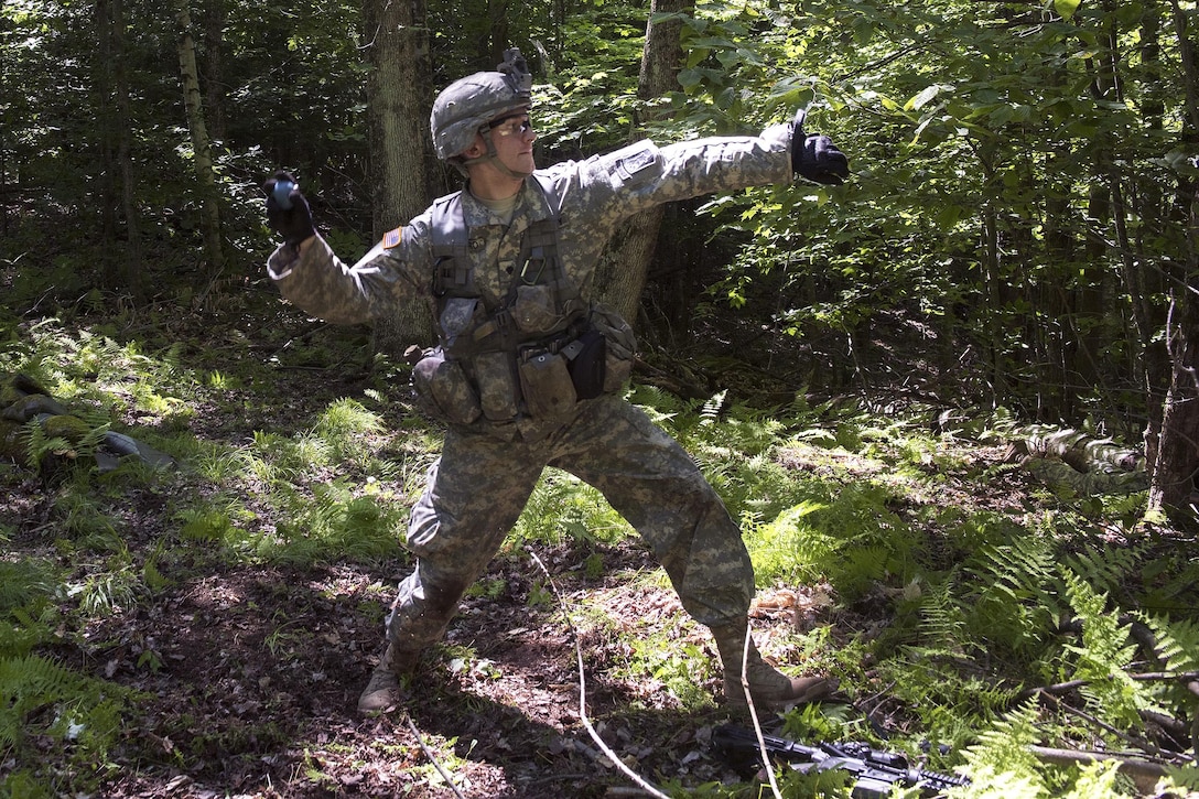 Army Spc. John Nicastro prepares to throw a smoke grenade during annual training at Camp Ethan Allen Training Site, Jericho, Vt., June 15, 2016. Nicastro is assigned to the Vermont National Guard’s Company A, 3rd Battalion, 172nd Infantry Regiment, 86th Infantry Brigade Combat Team. The unite is participating in an assault lane as part of a buddy-team exercise during his two-week annual training. Air National Guard photo by Tech. Sgt. Sarah Mattison
