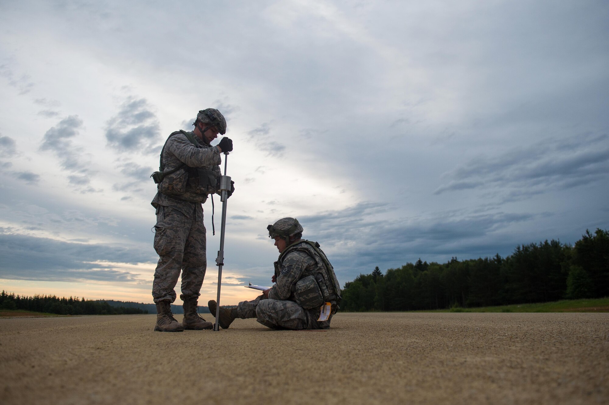 U.S. Air Force Capt. Jerry Carroll, left, 821st Contingency Response Squadron engineer, and Tech. Sgt. Johnathan Silsley, 921st CRS engineer assistant conduct an airfield assessment during Exercise Swift Response 16 at Hohenfels Training Area, Germany, June 16, 2016. Exercise SR16 is one of the premier military crisis response training events for multinational airborne forces in the world, the exercise has more than 5,000 participants from 10 NATO nations. (U.S. Air Force photo by Master Sgt. Joseph Swafford/Released) 