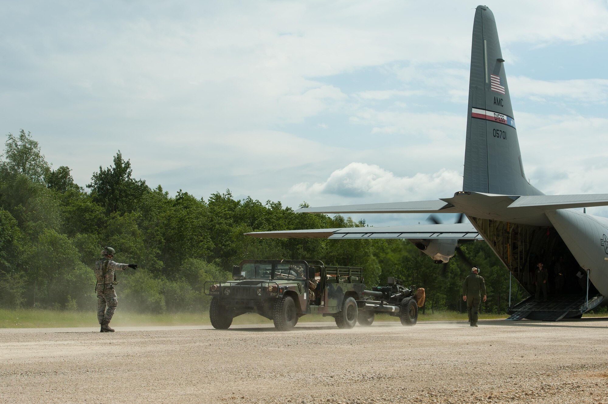 A U.S. Airmen from the 821st Contingency Response Group directs a Humvee being off loaded from a C-130J Super Hercules aircraft assigned to Dyess Air Force Base, Texas, during Exercise Swift Response 16 at Hohenfels Training Area, Germany, June 16, 2016. Exercise SR16 is one of the premier military crisis response training events for multinational airborne forces in the world, the exercise has more than 5,000 participants from 10 NATO nations. (U.S. Air Force photo by Master Sgt. Joseph Swafford/Released) 

