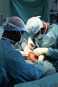 (From left) Maj. Chadwick Hampton, an orthopedic surgeon with the 212th Combat Support Hospital (CSH), assists Dr. Nguiabanda Leandre, a civilian surgeon with the Hopital D’Instrruction Des Armees in Libreville, Gabon, as he performs surgery during a medical readiness training exercise, known as MEDRETE 16-4. The exercise, held from May 22 to June 10, is a combined effort between the Gabonese government, U.S. Army Africa, the 212th CSH and the 3rd Medical Command (Deployment Support) from the U.S. Army Reserve. The exercise serves as an opportunity for U.S. and Gabonese forces to hone and strengthen their life saving skills as well as reinforce the partnership between both countries. (U.S. Army Africa photo by Capt. Charles An)