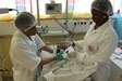 U.S. Army nurse feeds a Gabonese infant in NICU as Gabonese nurse assists