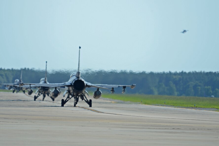 U.S. Air Force pilots assigned to the 20th Fighter Wing taxi on the runway during a surge at Shaw Air Force Base, S.C., June 21, 2016. The surge aided the 20th FW in gaining flying hours lost due to inclement weather and other unsafe flying conditions. (U.S. Air Force photo by Airman 1st Class Christopher Maldonado)