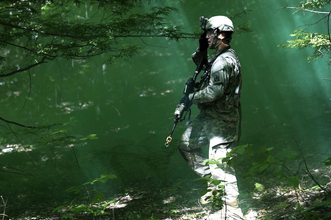 Army Spc. Steve Spinazola advances through the woods under the cover of smoke to his next objective during annual training at Camp Ethan Allen Training Site, Jericho, Vt., June 15, 2016. Spinazola is assigned to the Vermont National Guard’s Company A, 3rd Battalion, 172nd Infantry Regiment, 86th Infantry Brigade Combat Team. Air National Guard photo by Tech. Sgt. Sarah Mattison