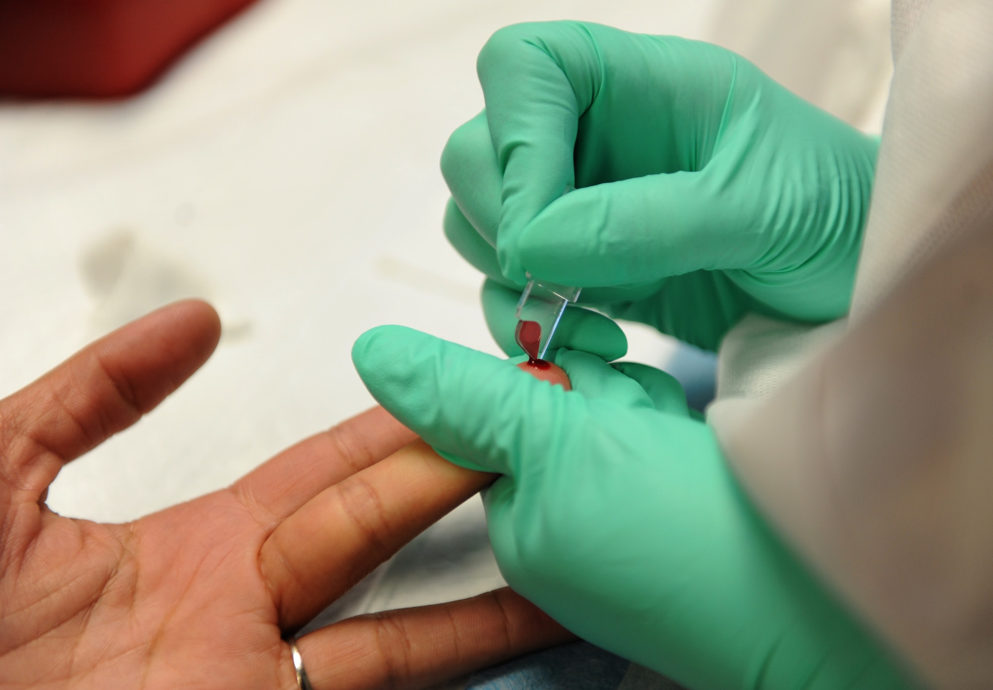 Wendy Ortega, 81st Diagnostic and Therapeutics Squadron medical lab technician, collects a blood sample from Airman Amia Hammett, 336th Training Squadron, during a blood drive at the Sablich Center June 21, 2016, Keesler Air Force Base, Miss. To donate you must be at least 18 years old, have been feeling well for at least three days, be well hydrated and have eaten prior to donating. Tattoos, acupuncture, foreign travel and some immunizations can defer volunteers from donating for up to 12 months. The Keesler Blood Donor Center is located in the 81st Medical Group's Arnold Medical Annex. (U.S. Air Force photo by Kemberly Groue)