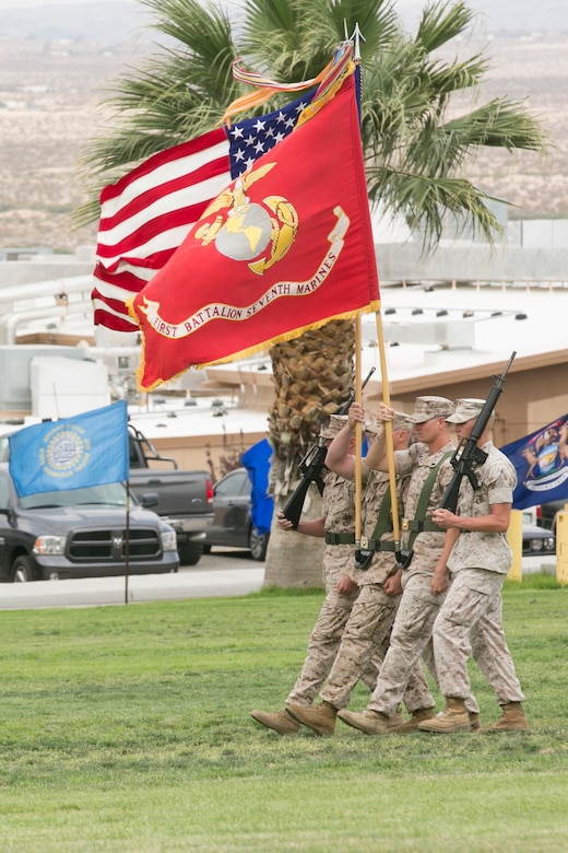 The 1st Battalion, 7th Marine Regiment color guard march with the national and Marine Corps colors during the battalion’s change of command ceremony at Lance Cpl. Torrey L. Gray Field, June 21, 2016. During the ceremony, Lt. Col. David Hart relinquished command of the battalion to Lt. Col. Erick Clark. (Official Marine Corps photo by Cpl. Thomas Mudd/Released)