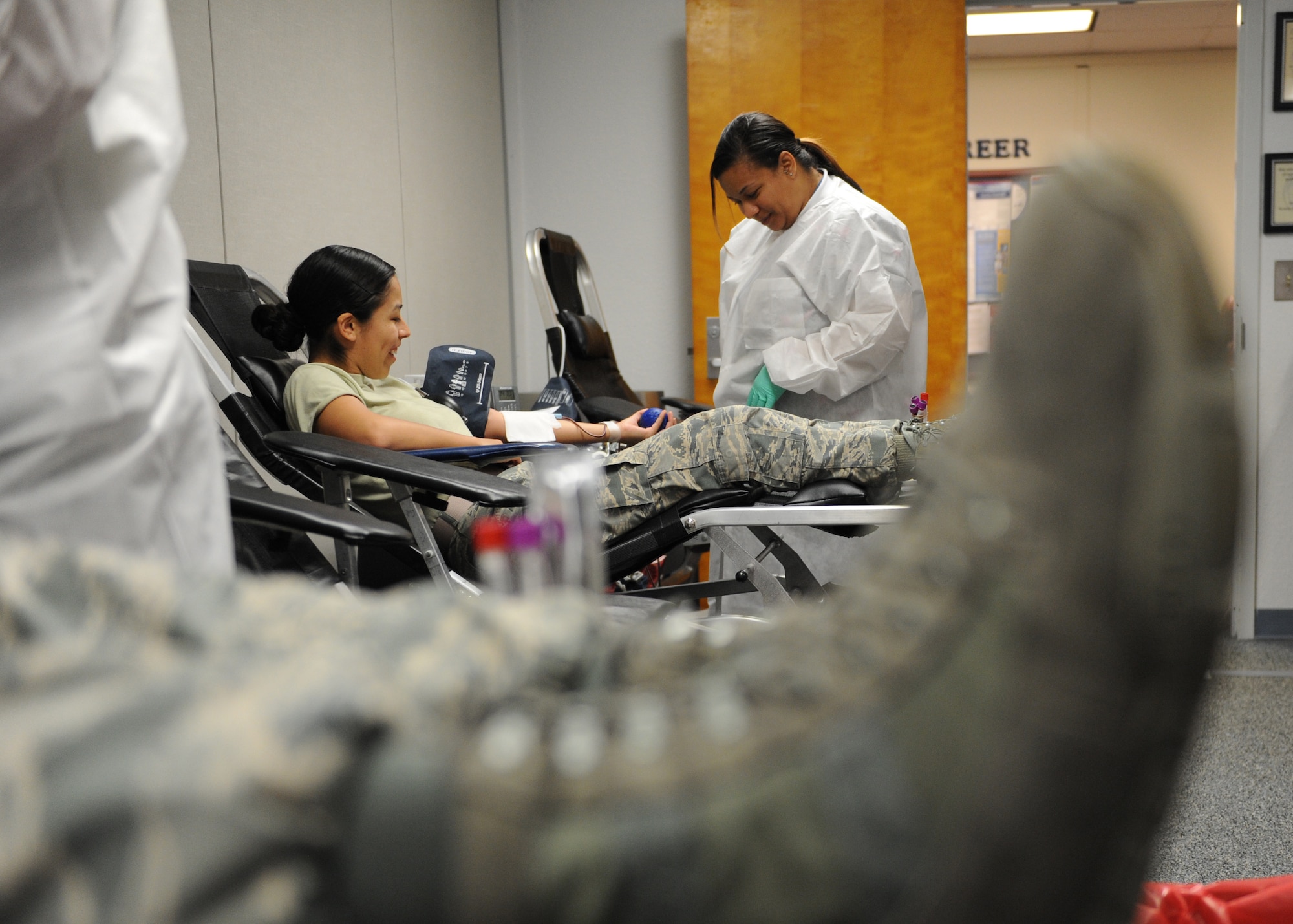 Airman Brenda Prudencio, 81st Force Support Squadron customer support specialist, has her blood drawn by Amber Horne, 81st Diagnostic and Therapeutics Squadron medical lab technician, during a blood drive at the Sablich Center June 21, 2016, Keesler Air Force Base, Miss. To donate you must be at least 18 years old, have been feeling well for at least three days, be well hydrated and have eaten prior to donating. Tattoos, acupuncture, foreign travel and some immunizations can defer volunteers from donating for up to 12 months. The Keesler Blood Donor Center is located in the 81st Medical Group's Arnold Medical Annex. (U.S. Air Force photo by Kemberly Groue)