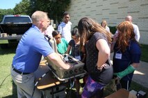 John Peters, a product manager at Marine Corps Systems Command, talks to students about a portable solar panel system used by Marines during the Quantico Middle/High School’s Science, Technology, Engineering and Math Summer Academy June 13-17 aboard Marine Corps Base Quantico, Virginia. The STEM Education Alliance—a partnership between the Department of Defense and the College of William and Mary—hosts the camp annually for the QMHS students. (U.S. Marine Corps photo by Mathuel Browne) 