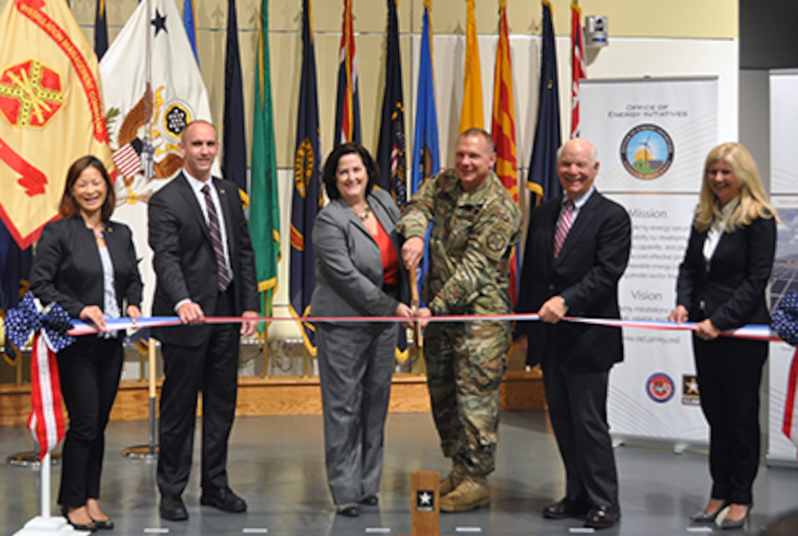 Defense Logistics Agency Energy Deputy Commander George Atwood [second to left] and other stakeholders participate in a ribbon-cutting ceremony with other senior officials for the large-scale renewable energy solar project at Fort Detrick, Maryland, June 17.