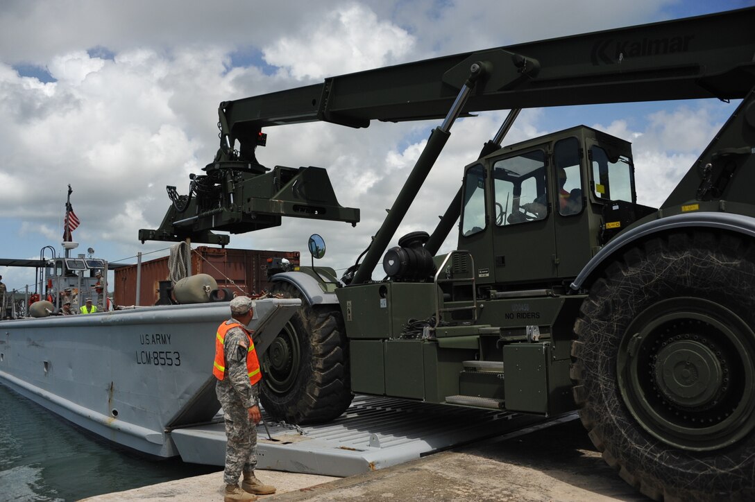 The 390th SPOC Soldiers moved 11,000-pound containers onto the LCM by utilizing a RTCH.