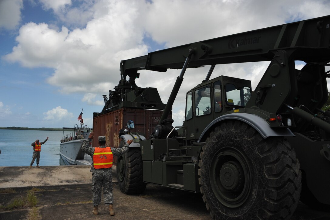 The 390th SPOC Soldiers moved 11,000-pound containers onto the LCM by utilizing a Rough Terrain Container Handler (RTCH).