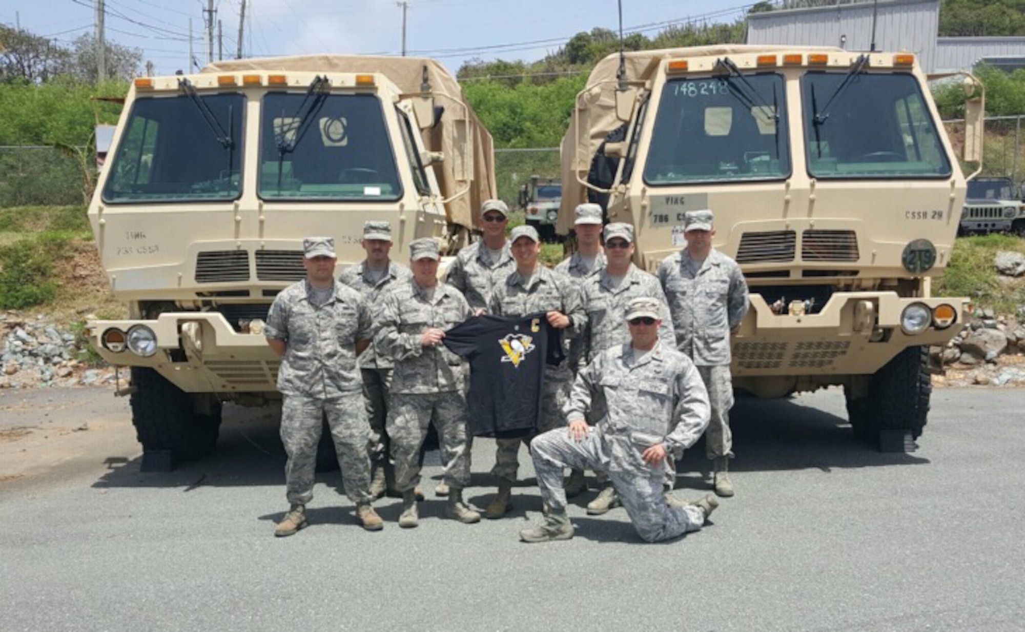 Nine Airmen from the 911th Communications Squadron pose for a photo at the Army National Guard 758th Combat Sustainment Support Battalion in the U.S. Virgin Islands, June 9, 2016. Members of the 911th CS spent 15 days at the 758th CSSB to help them set up an emergency communications system called a joint instant site communications capability package. (U.S. Air Force courtesy photo)