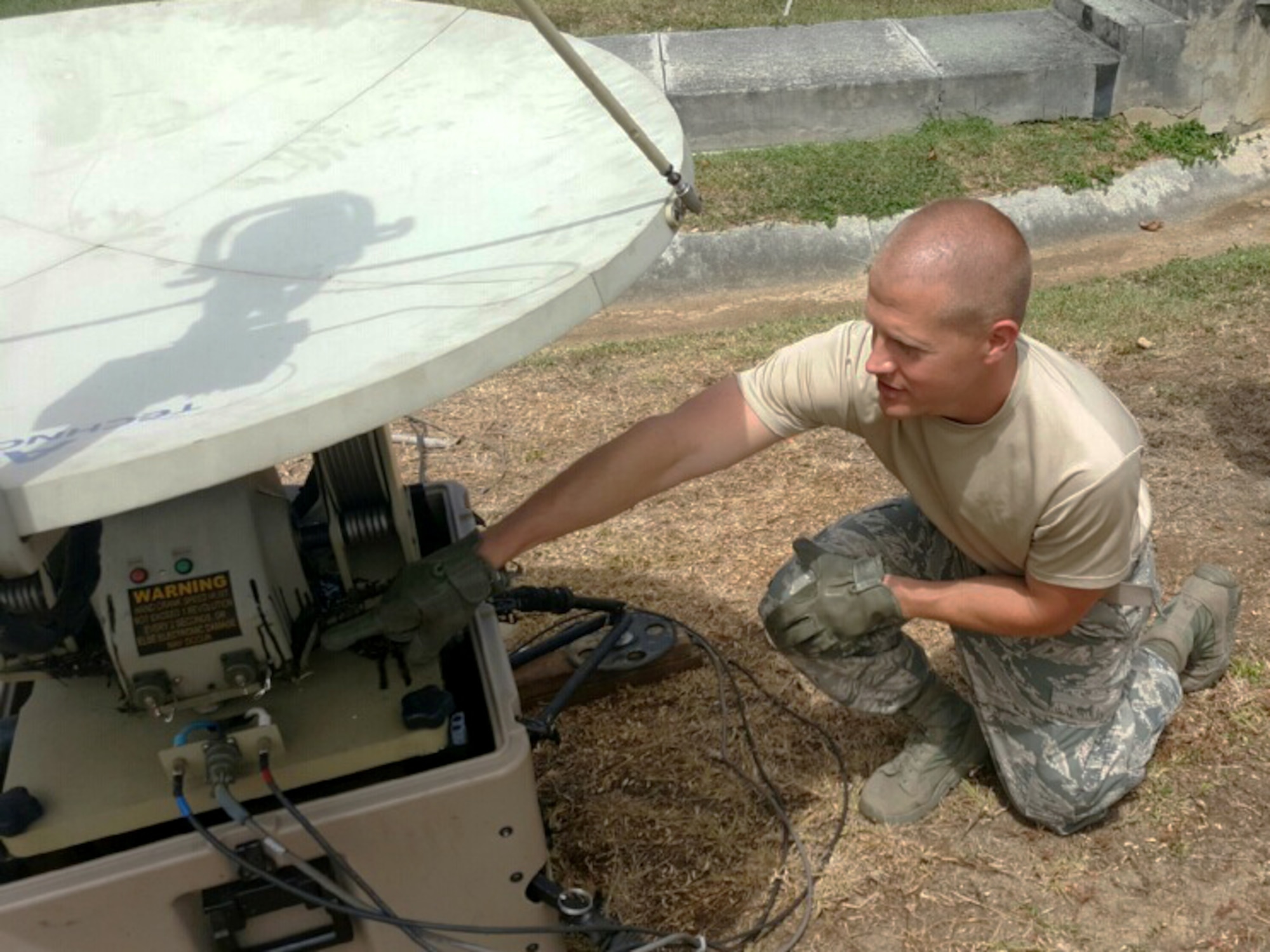 Staff Sgt. Brian Szupinka, client systems technician with the 911th Communications Squadron, sets up the satellite for a joint integrated site communications capability package for the Army National Guard 758th Combat Sustainment Support Battalion in the U.S. Virgin Islands, June 8, 2016. Szupinka was one of nine 911th CS Airmen who worked on the joint project. (U.S. Air Force courtesy photo by Technical Sgt. David Gross)