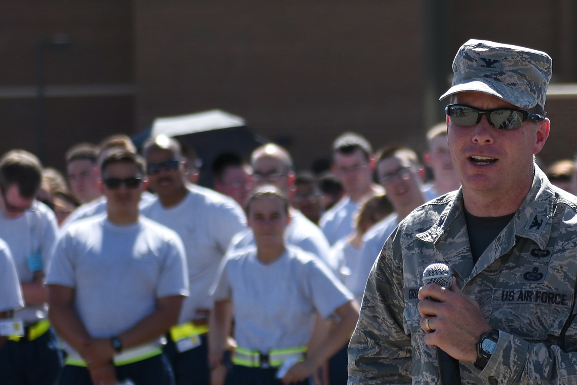 U.S. Air Force Col. Michael Grunwald Jr., 17th Training Group Commander, speaks to technical school students during the drill competition on the flight line at Goodfellow Air Force Base, Texas, June 22, 2016. The drill competition was Grunwald’s last opportunity to witness the black ropes competing before he leaves to a new duty station. (U.S. Air Force photo by Airman 1st Class Caelynn Ferguson/Released)