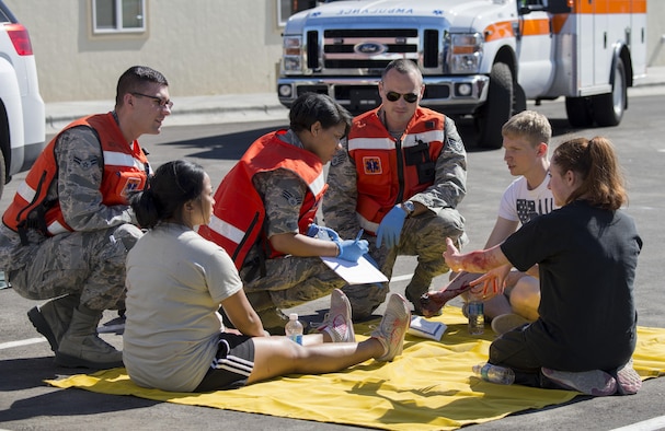 Military members assist simulated victims during an active shooter exercise June 23, 2016, in downtown Mountain Home, Idaho. The 366th Medical Group sent first responders to the scene within 20 minutes of receiving the call for assistance during the active shooter exercise.(U.S. Air Force photo by Senior Airman Jeremy L. Mosier/Released)