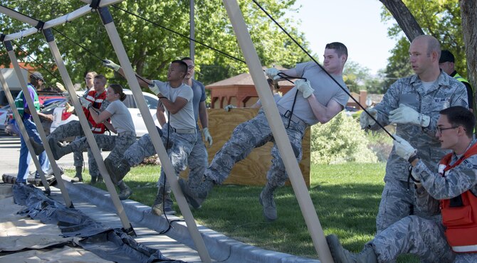 Members of the 366th Medical Group set up a tent for injured victims during an active shooter exercise June 23, 2016, in downtown Mountain Home, Idaho. The tent was setup to provide a safe location for the injured.(U.S. Air Force photo by Senior Airman Jeremy L. Mosier/Released)