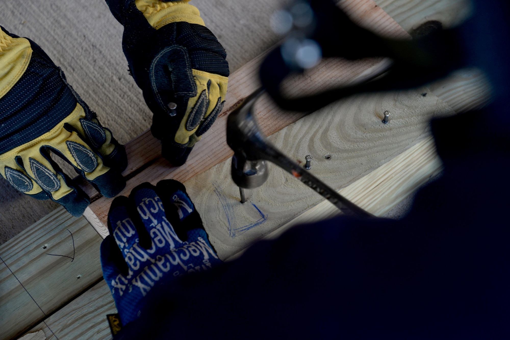 Members from the 97th Civil Engineer Squadron Fire Department and the City of Altus Fire Department build a structural support beam during a structural collapse exercise, June 21, 2016, Altus Air Force Base, Okla. The joint training between the two departments was held in an effort to improve the structural collapse rescue techniques and the relationship between the base and City of Altus Fire Departments. (U.S. Air Force Photo by Airman Jackson N. Haddon/Released).