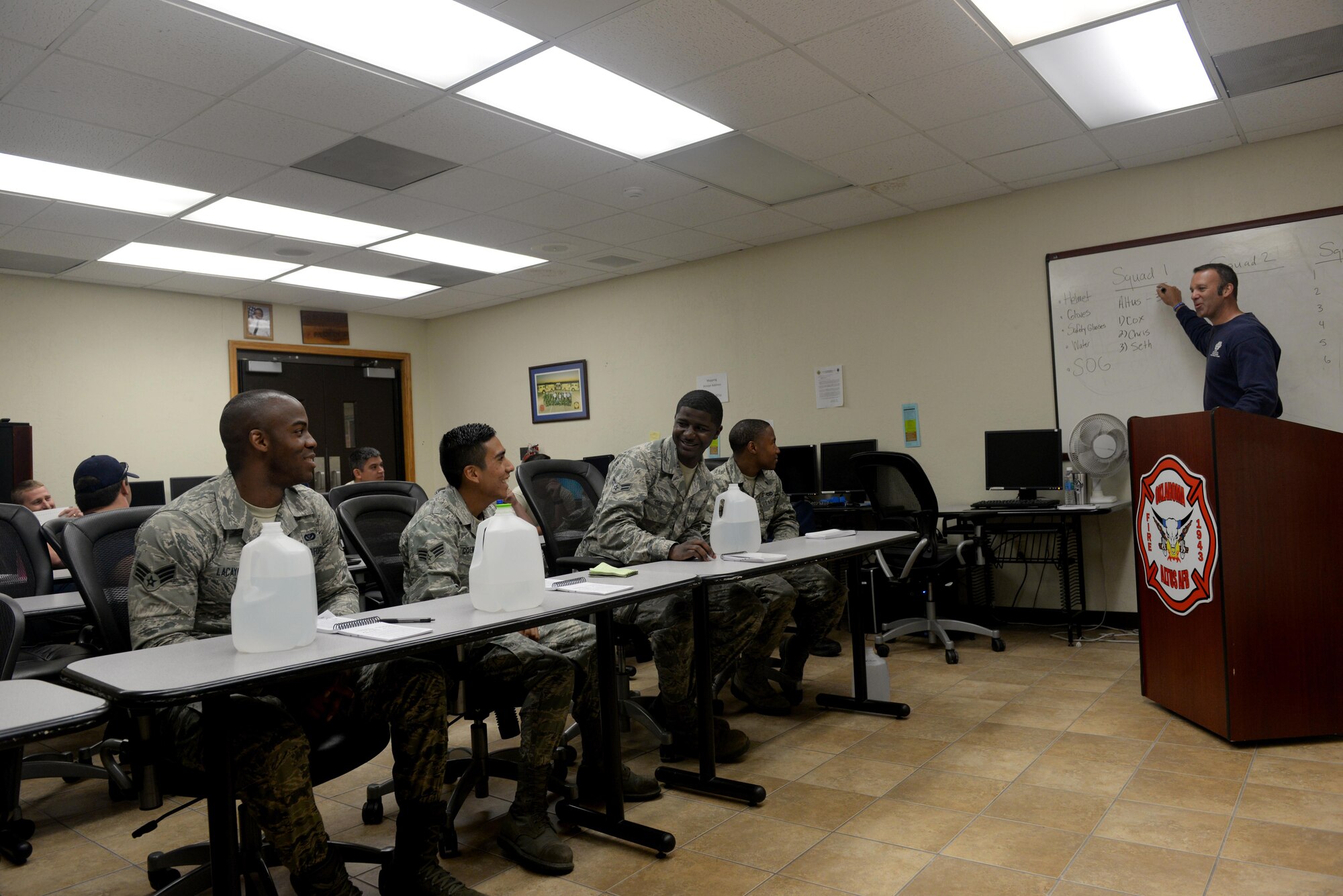 Members from the 97th Civil Engineer Squadron Fire Department and the City of Altus Fire Department are briefed at the base fire department before a structural collapse exercise, June 20, 2016, Altus Air Force Base, Okla. The joint training between the two departments was held in an effort to improve the structural collapse rescue techniques and the relationship between the base and City of Altus Fire Departments. (U.S. Air Force Photo by Airman Jackson N. Haddon/Released).