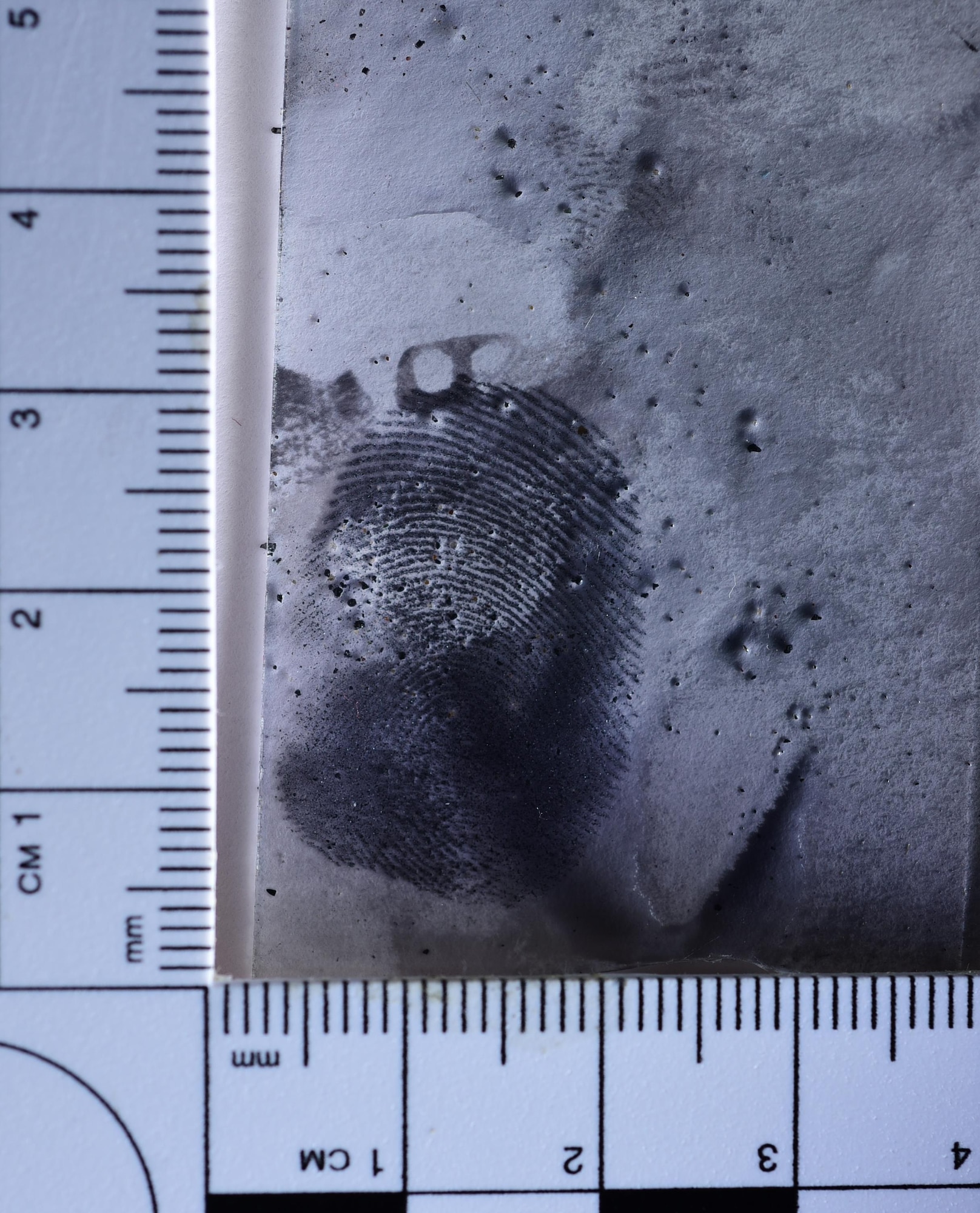 PETERSON AIR FORCE BASE Colo. – A lifted finger print is measured during a crime scene photography class at the 21st Security Forces Training Complex on Peterson Air Force Base, Colo., June 10, 2016. The Air Force Office of Special Investigations special agents from the 8th Field Investigations Squadron teamed up with 21st Security Forces Squadron investigators and 21st Space Wing Public Affairs alert photographers to practice forensic evidence collection and training. (U.S. Air Force photo by Staff Sgt. Amber Grimm)

