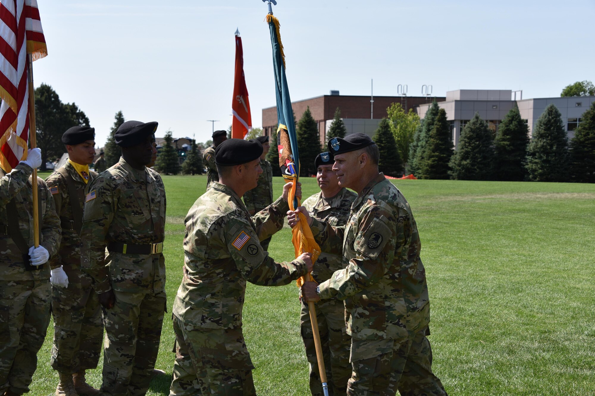 PETERSON AIR FORCE BASE, Colo. - Incoming 1st Space Brigade Commander Col. Richard Zellmann, left, receives the brigade colors from Lt. Gen. David Mann, commander, U.S. Army Space and Missile Defense Command/Army Forces Strategic Command, June 21 during a change of command ceremony at Patriot Park, Peterson Air Force Base, Colo. (Photo by Dottie K. White)