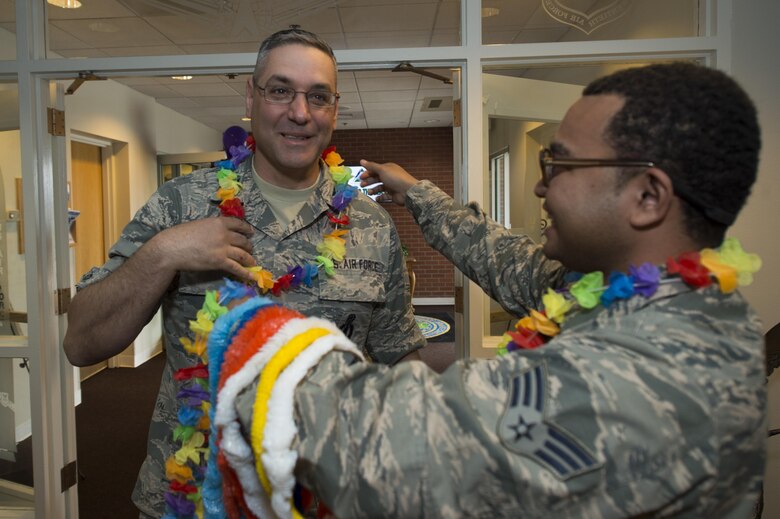 Col. Stephen M. Kravitsky, 90th Missile Wing commander, receives a Hawaiian Lei from Senior Airman Justin Tua, 790th Maintenance Squadron maintenance scheduler, during the Joint Services Multicultural Event at F.E. Warren Air Force Base, Wyo., June 22, 2016. The multicultural event was a collaborative effort between the 90th Missile Wing, the 153rd Airlift Wing, and the Army National Guard to celebrate military diversity.  (U.S. Air Force photo by Staff Sgt. Christopher Ruano)