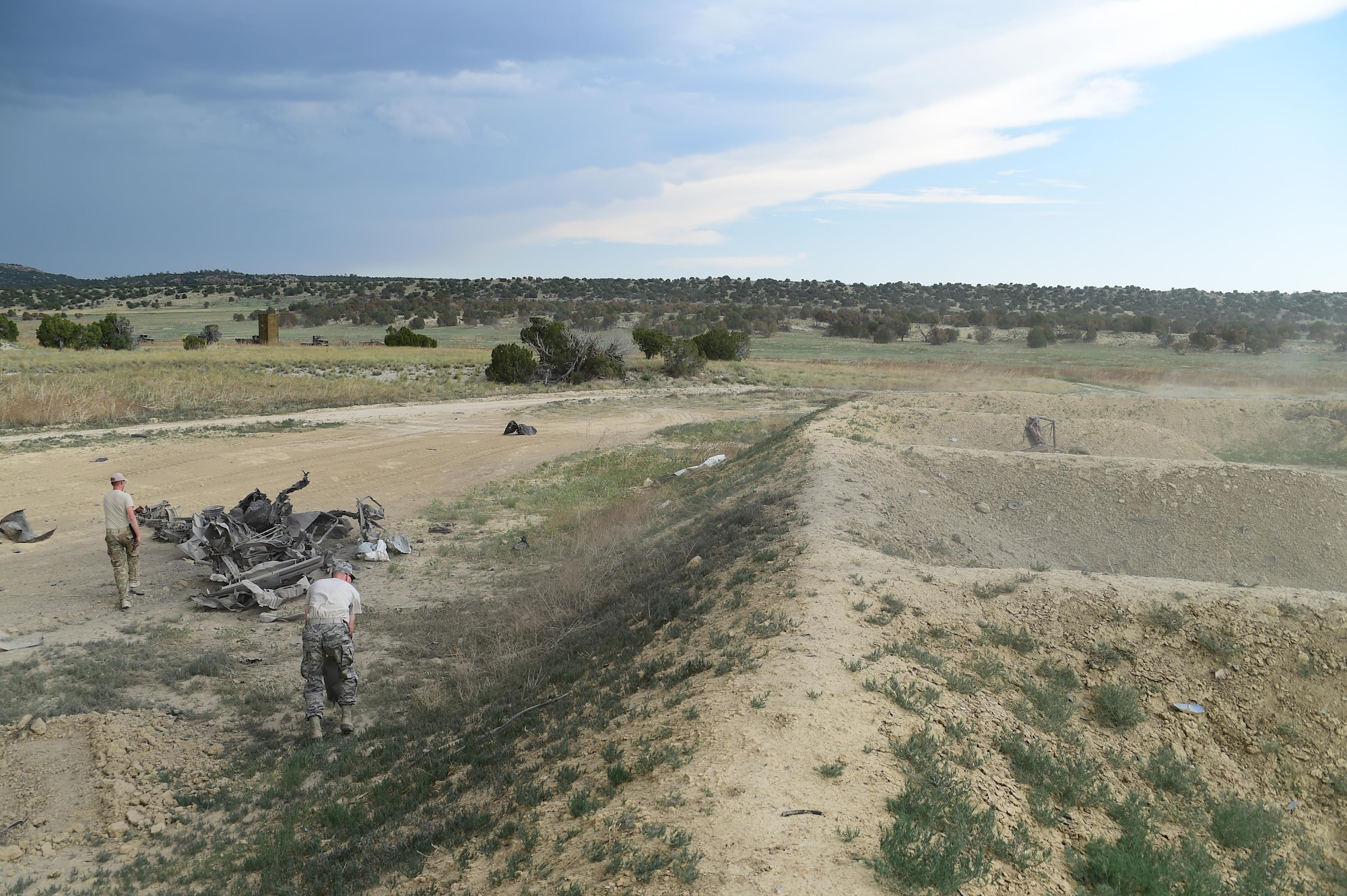 The remnants of a vehicle used for ordnance testing by 140th Explosives Ordnance Disposal lies 50 feet outside the blast pit June 23, 2016, at the Airburst Range on Fort Carson, Colo. The vehicle had been turned into a pile of twisted metal by a controlled explosion. (U.S. Air Force photo by Airman 1st Class Luke W. Nowakowski/Released)