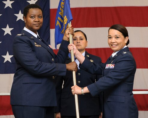 Lt. Col. Tam Dinh, right, accepts the 71st Medical Operations Squadron guidon from Col. Kirsten Benford, 71st Medical Group commander, during a change-of-command ceremony June 24, at Vance Air Force Base, Oklahoma. (U.S. Air Force photo/ David Poe)
