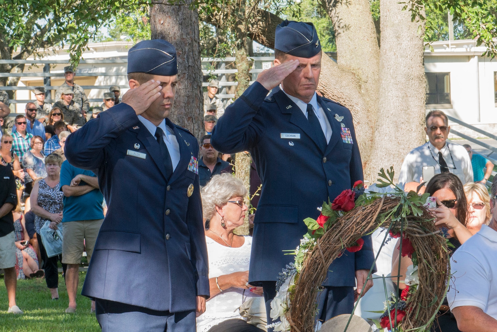 Col. Lance Pilch, 33rd Fighter Wing commander, and retired Col. Doug Cochran, commander of the 58th Tactical Fighter Squadron at the time of the Khobar Towers bombing, salute the Khobar Towers Memorial Ceremony wreath June 24, 2016, at Eglin Air Force Base, Fla. The 33rd FW hosted a ceremony commemorating the 20th anniversary of the Khobar Towers terrorist attack to honor the 19 Airmen who lost their lives, 12 of which were Nomads, and pay tribute to the families and survivors. (U.S. Air Force photo by Senior Airman Stormy Archer/Released)