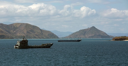 A Papua New Guinean naval ship heads toward USNS Sacagawea (T-AKE 2) for Task Force Koa Moana to disembark their gear and personnel, off the coast of Port Moresby, Papua New Guinea, June 17, 2016. This marks the first time the Papua New Guinea Defence Force and U.S. Marines will train together directly. Papua New Guinea is the second of four destinations for the task force during their deployment in the Asia-Pacific region. Their deployment consists of multiple multi-national, bilateral exercises designed to increase the interoperability and relations between participating nations by sharing infantry, engineering, law enforcement and medical skills. The Marines and Sailors are originally assigned to I and III Marine Expeditionary Force. 
