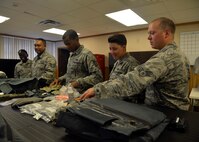Immersion Program participants look through items used in a parachute bag June 24, 2016 at Luke Air Force Base, Ariz. The Immersion Program gives Airmen the opportunity to experience the Air Force from a different perspective. ((U.S. Air Force photo by Senior Airman Devante Williams)