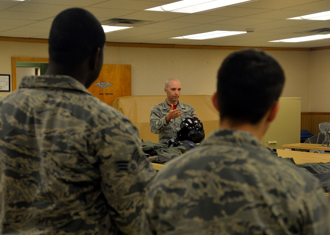 Senior Airman Zachary Newman, 56th Operation Support Squadron aircrew flight equipment technician, shows Immersion Program participants the F-35 Lightning II helmet June 24, 2016 at Luke Air Force Base, Ariz. The Immersion Program gives Airmen the opportunity to experience the Air Force from a different perspective.  (U.S. Air Force photo by Senior Airman Devante Williams)