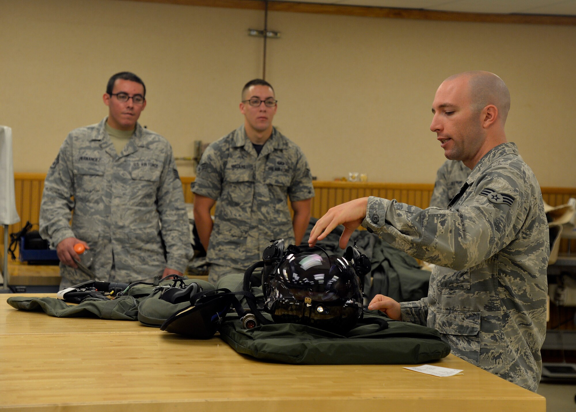 Senior Airman Zachary Newman, 56th Operation Support Squadron aircrew flight equipment technician, shows  Immersion Program participants the F-35 Lightning II helmet June 24, 2016 at Luke Air Force Base, Ariz. The Immersion Program gives Airmen the opportunity to experience the Air Force from a different perspective.  (U.S. Air Force photo by Senior Airman Devante Williams)