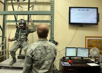 Senior Airman Bryce Gardner, 56th Operation Support Squadron aircrew flight equipment technician, watches the screen as Airman Basic Clayton Selman, 56th Fighter Wing judge advocate legal office apprentice, simultaneously steers to safety June 24, 2016 at Luke Air Force Base, Ariz. Senior Airman Zachary Newman, 56th Operation Support Squadron aircrew flight equipment, shows the Immersion Program participants the F-35 Lightning II helmet June 24, 2016 at Luke Air Force Base, Ariz. The Immersion Program gives Airmen the opportunity to experience the Air Force from a different perspective. (U.S. Air Force photo by Senior Airman Devante Williams)
