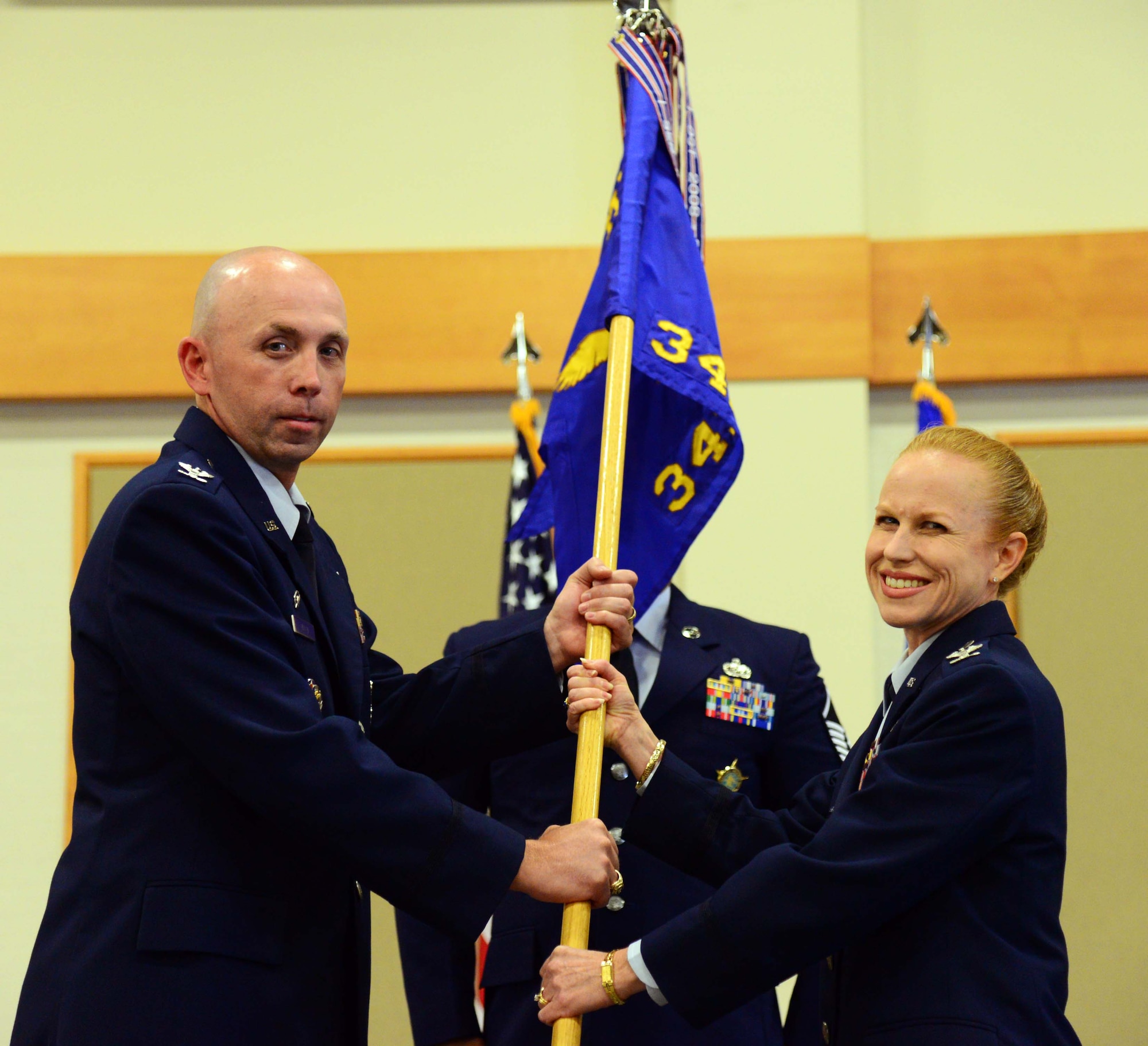 Col. Anita Feugate Opperman, right, accepts command of the 341st Operations Group from Col. Ron Allen, 341st Missile Wing commander, during a change of command ceremony at the Malmstrom Air Force Base Grizzly Bend June 24, 2016. (U.S. Air Force photo/Airman 1st Class Magen M. Reeves)