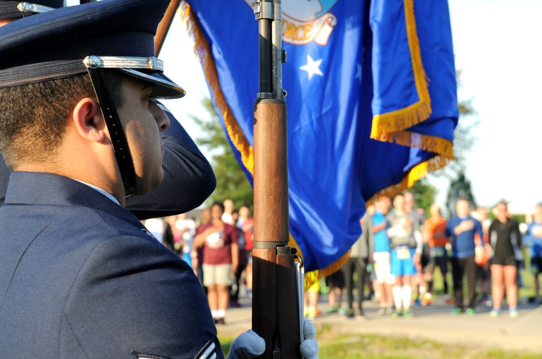 Members of the Whiteman Honor Guard post the colors as participants pay respects during the national anthem before the start of the fifth-annual Striker Life run at Whiteman Air Force Base, Mo., May 21, 2016. The half-marathon, 10K and 5K race started as an Air Force Global Strike Command initiative designed to promote physical fitness and build resiliency. Whiteman has continued this legacy, improving the race and gaining more runners from throughout the U.S. each year. (U.S. Air Force photo by Tech. Sgt. Miguel Lara III)