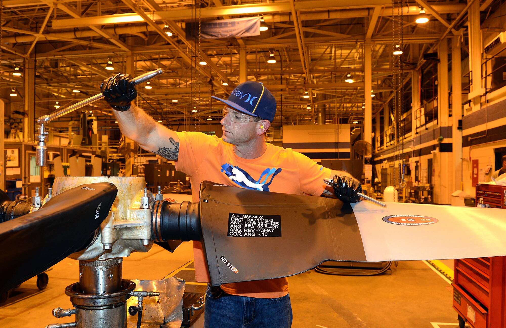 Steven Vann, 572nd Commodities Maintenance Squadron aircraft propeller mechanic, tightens barrel bolts on a C-130 propeller prior to testing. Propellers make their way through five gates, or work processes, at the Warner Robins Air Logistics Complex. (U.S. Air Force photo by Tommie Horton)