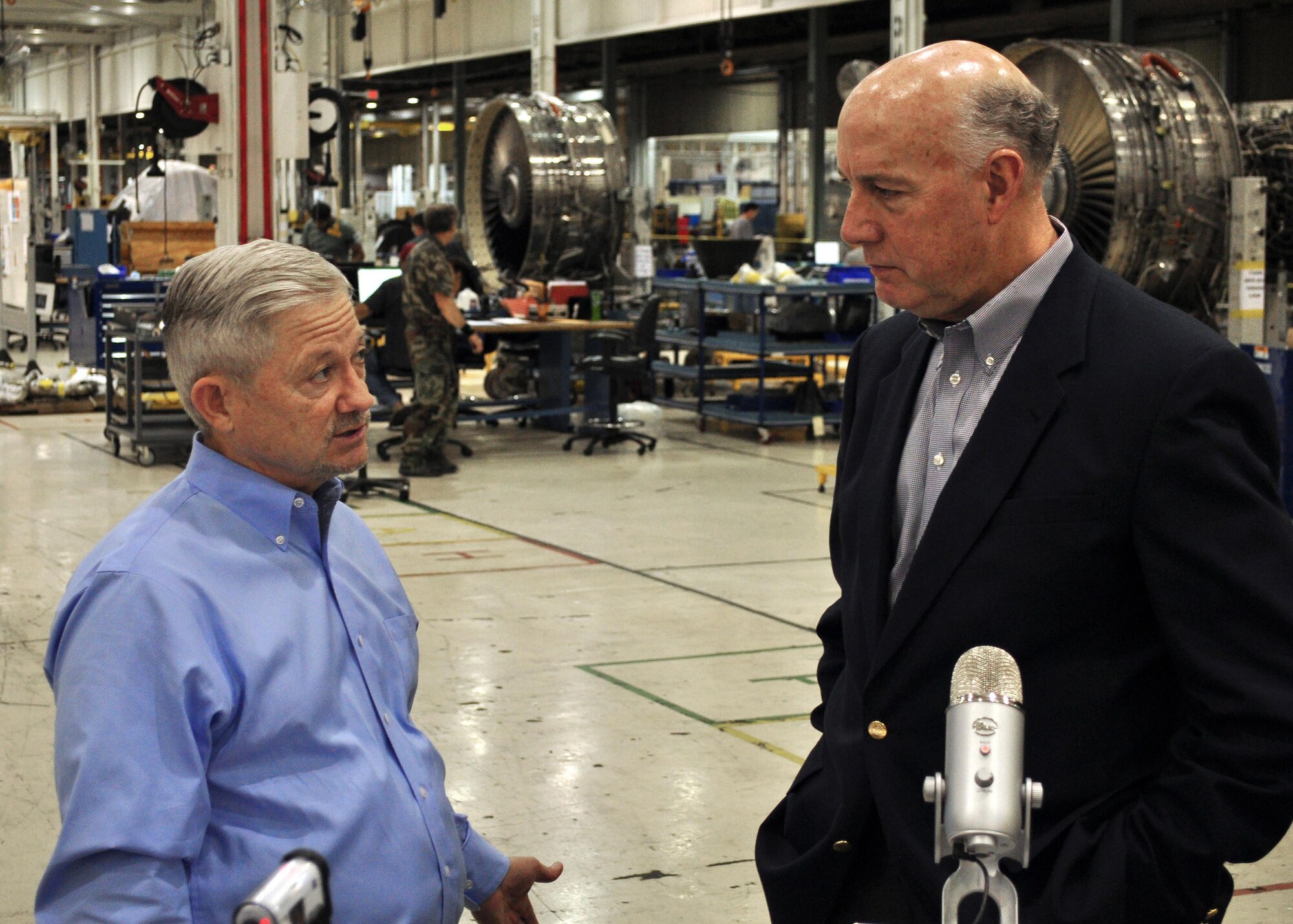Oklahoma County Commissioner Ray Vaughn speaks with Lloyd Kirk, director of External Affairs for the Oklahoma Department of Environmental Quality, about the redevelopment of the former GM plant, now a major facility in use by the Oklahoma City Air Logistics Complex. The department is launching a series of success stories in environmental management on social media in Oklahoma later this month. (Air Force photo by Marlin Zimmerman/Released)