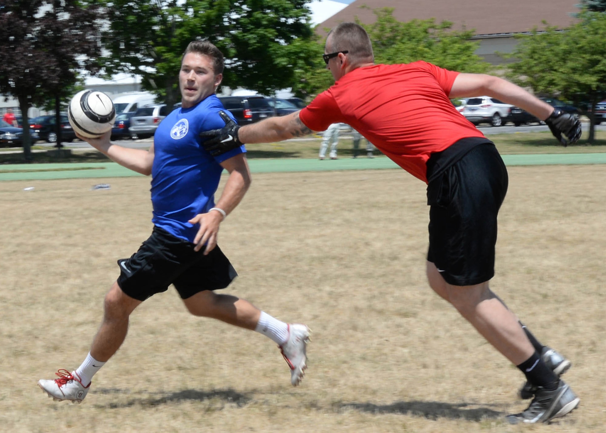 1st Lt. Erik Smith, C3I and Networks program manager, attempts to evade Staff Sgt. Daniel Fox, 66th Security Forces Squadron standardization and evaluations, during an Special Programs Division Invitational Gatorball Tournament on base June 24. The tournament, hosted by last year's tournament winners, included teams in a double elimination format. Gatorball combines elements of soccer and rugby (U.S. Air Force photo by Linda LaBonte Britt)