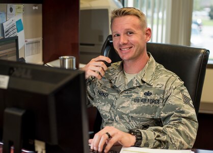 Staff Sgt. Matt Parker, 628th Air Base Wing command chief executive assistant, takes a phone call June 14, 2016, at Joint Base Charleston, S.C. Parker plans to take his child to the park to watch fireworks during the 4th of July. He also plans to reflect on the meaning of freedom and honor the many sacrifices those before him endured.  (U.S. Air Force photo/Staff Sgt. Jared Trimarchi)