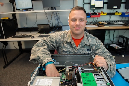 Airman Marc Galui, a 628th Communications Squadron client system technician, smiles while fixing a computer May 17, 2016 at Joint Base Charleston, S.C. Galui is looking forward to having his family from Detroit, Mich. visit him during the upcoming 4th of July weekend. Independence Day makes him feel proud to serve and is a time to reflect on the price of freedom. (U.S. Air Force photo/Staff Sgt. Jared Trimarchi) 