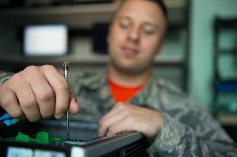 Airman Marc Galui, a 628th Communications Squadron client system technician, tightens a screw on a computer May 17, 2016 at Joint Base Charleston, S.C. Galui is looking forward to having his family from Detroit, Mich. visit him during the upcoming 4th of July weekend. Independence Day makes him feel proud to serve and is a time to reflect on the price of freedom. (U.S. Air Force photo/Staff Sgt. Jared Trimarchi) 